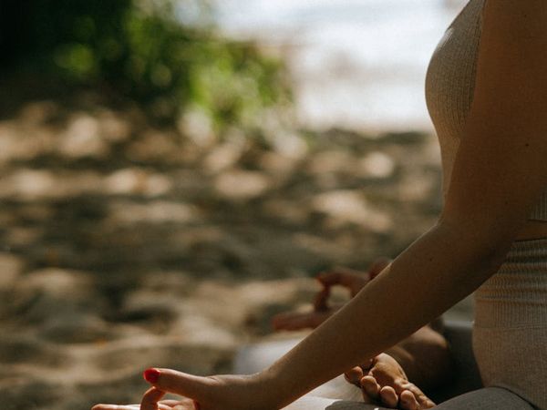 Person meditating peacefully in a serene environment.